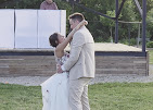 Newlyweds embracing on the venue grounds