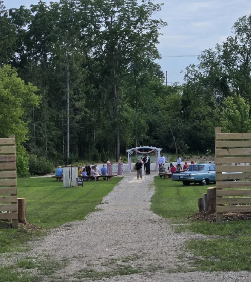 Outdoor wedding ceremony on the lawn at The Nuthouse